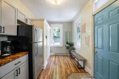 a kitchen with a blue door and a wooden floor at Spacious Broadway Home Downtown Western Modern Charm with parking in Jim Thorpe