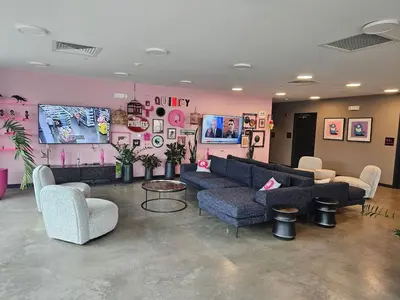 a living room with couches and a pink wall at Chic 1BR Old City Apt with King Bed, City View, and Gym in Philadelphia