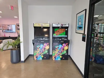 two soda machines are lined up against a wall at Chic 1BR Old City Apt with King Bed, City View, and Gym in Philadelphia