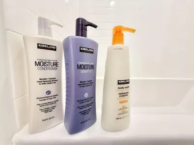 three bottles of sunscreen sitting on a bathroom sink at Chic 1BR Old City Apt with King Bed, City View, and Gym in Philadelphia