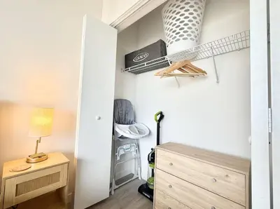 a room with a bed and a desk and a lamp at Studio Apt with City View, Rooftop and Gym in Philadelphia