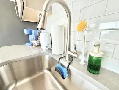 a kitchen sink with a faucet and a sink at Studio Apt with City View, Rooftop and Gym in Philadelphia