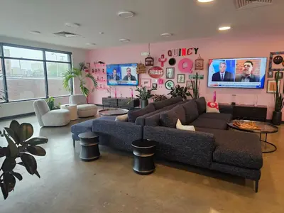 a living room with two couches and a tv at Boutique Studio with Rooftop View and Gym in Philadelphia