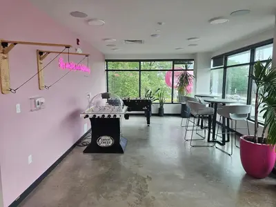 a pink room with a table and a piano at Boutique Studio with Rooftop View and Gym in Philadelphia