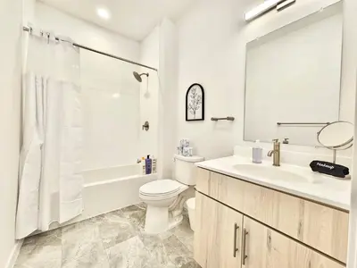 a white bathroom with a toilet and a sink at 2 BR in the heart of an old city in Philadelphia