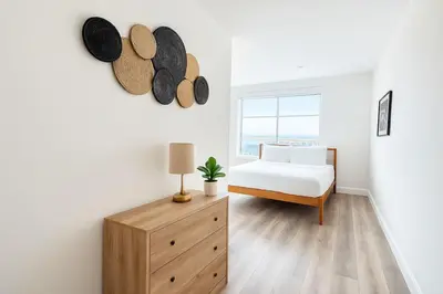 a bedroom with a bed and a dresser with hats on the wall at 2 BR in the heart of an old city in Philadelphia