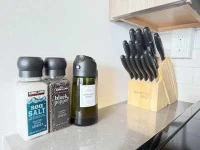 a counter with two bottles of essential oils and a knife block at 2 BR in the heart of an old city in Philadelphia