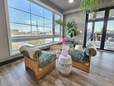 a living room with couches and a large window at Central Philly 1Br Apt with Gym in Philadelphia