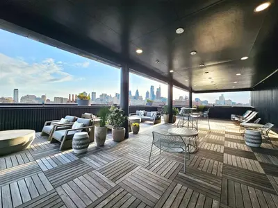 a rooftop patio with furniture and a view of the city at Central Philly 1Br Apt with Gym in Philadelphia