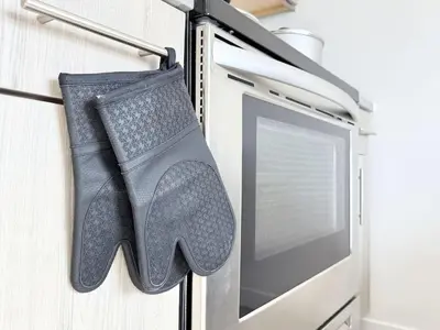 a pair of gloves hanging on a wall next to a computer monitor at Studio Apt with Skyline Views, King Bed, and Gym in Philadelphia