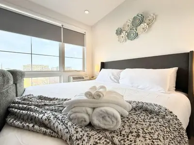 a bedroom with a bed with towels on it at Studio Apt with Skyline Views, King Bed, and Gym in Philadelphia