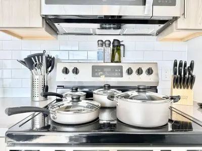 a kitchen stove with three pots and pans on it at Philly Central King 1BR with Gym in Philadelphia