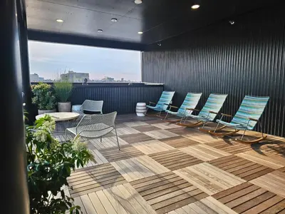 a group of chairs and tables on a patio at Philly Central King 1BR with Gym in Philadelphia