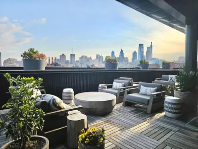 a rooftop patio with a view of a city at Philly Central King 1BR with Gym in Philadelphia