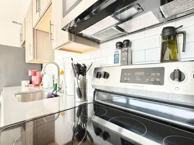 a kitchen with a stove and a sink at 1BR Apt King Bed FREE Parking Gym - RoofTop 609 in Philadelphia
