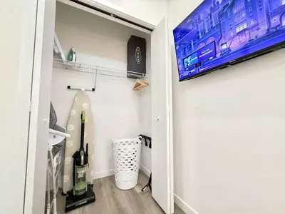 a walk in closet with a tv on the wall at 1BR Apt King Bed FREE Parking Gym - RoofTop 609 in Philadelphia