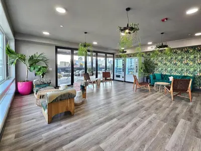 a lobby with couches and chairs and tables and windows at 1BR Apt King Bed FREE Parking Gym - RoofTop 609 in Philadelphia