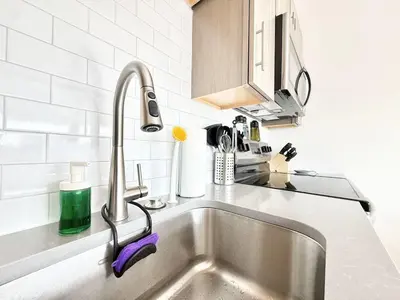 a kitchen sink with a faucet on a counter at 1BR Apt King Bed FREE Parking Gym - RoofTop 609 in Philadelphia
