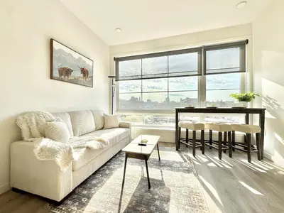 a living room with a couch and a table at 1BR Apt King Bed FREE Parking Gym - RoofTop 609 in Philadelphia