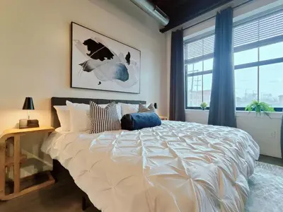 a bedroom with a large white bed and a window at Cozy Philly Studio with Free Parking for Long Term Stays in Philadelphia