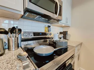 a kitchen with a stove with pots and pans at Cozy Philly Studio with Free Parking for Long Term Stays in Philadelphia
