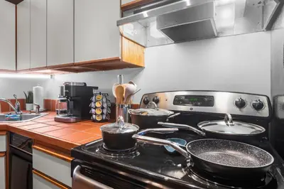 a kitchen with two pots and pans on a stove at Quaint and Stylish APT with King Bed for Long Term Stay in Philadelphia