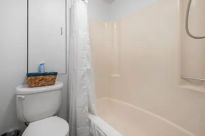 a white bathroom with a toilet and a shower at Quaint and Stylish APT with King Bed for Long Term Stay in Philadelphia