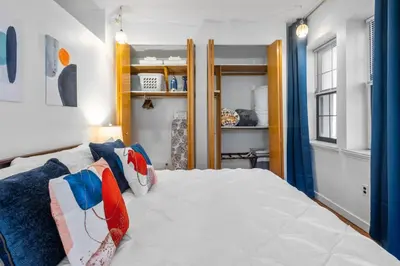 a bedroom with a large white bed with pillows at Quaint and Stylish APT with King Bed for Long Term Stay in Philadelphia