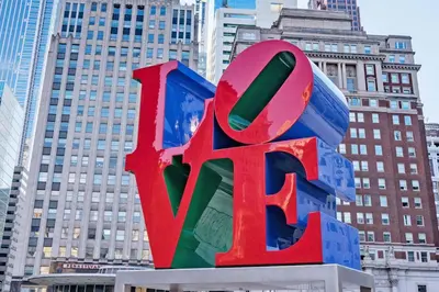 a large react sign in front of some tall buildings at Quaint and Stylish APT with King Bed for Long Term Stay in Philadelphia