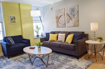 a living room with a couch and a table at Old City Apt Near Independent Hall and Liberty Bell in Philadelphia