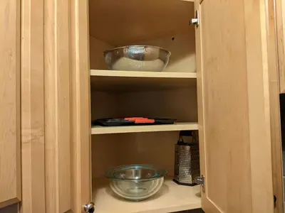 a cupboard with a bowl and other items in it at Old City Apt Near Independent Hall and Liberty Bell in Philadelphia