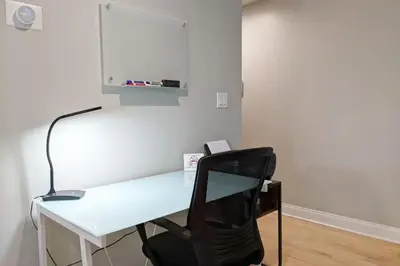 a desk with a black chair next to a white wall at Old City Apt Near Independent Hall and Liberty Bell in Philadelphia