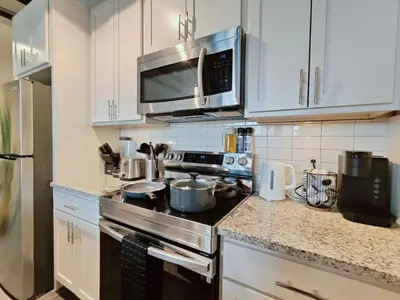 a kitchen with a stove and a microwave at Studio Apt Near Temple Unit with Free Parking for Extended Stays in Philadelphia