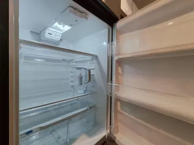 an empty refrigerator with its door open and empty shelves at Studio Apt Near Temple Unit with Free Parking for Extended Stays in Philadelphia