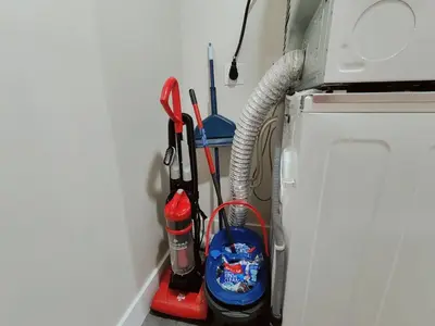 a corner of a room with cleaning tools on a wall at Studio Apt Near Temple Unit with Free Parking for Extended Stays in Philadelphia