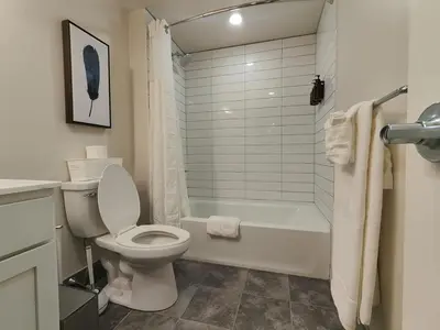a bathroom with a toilet and a tub and a sink at Studio Apt Near Temple Unit with Free Parking for Extended Stays in Philadelphia