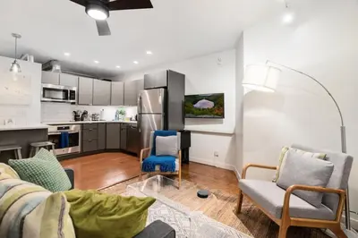 a living room with a couch and chairs and a kitchen at Chic Apartment with King Bed in Old City in Philadelphia