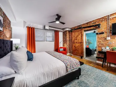 a bedroom with a bed and a brick wall at Charming 1BR in Philly with Courtyard View in Philadelphia