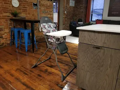 a chair sitting next to a counter in a kitchen at Charming 1BR in Philly with Courtyard View in Philadelphia