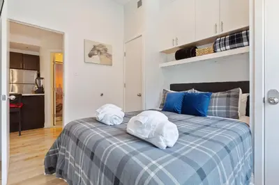 a bedroom with a bed with towels on it at Old City Apartment with Full Kitchen in Philadelphia
