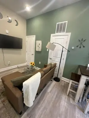 a living room with a couch and a flat screen tv at Downtown Philly 1BR with Stunning Views in Philadelphia