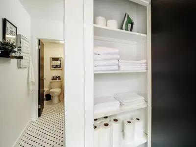 a bathroom with a closet with towels and a toilet at Tasteful 1 Bedroom Apt in Historic Old City in Philadelphia
