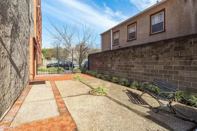 a brick wall with a bench next to a building at Tasteful 1 Bedroom Apt in Historic Old City in Philadelphia
