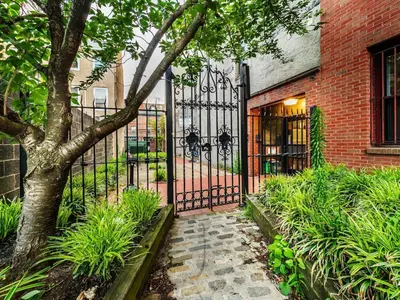 an iron gate in front of a brick building at Tasteful 1 Bedroom Apt in Historic Old City in Philadelphia