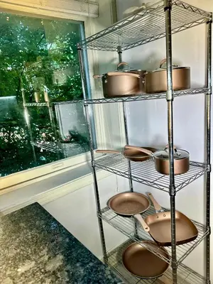a shelf with pots and pans in a kitchen at BP STAYS - Hotel-Style, No Host, Professionally Managed ID302 in Jersey City