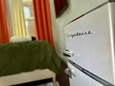 a white refrigerator freezer sitting in a room at BP STAYS - Hotel-Style, No Host, Professionally Managed ID302 in Jersey City