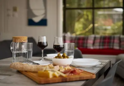 a table with two glasses of wine and a plate of food at Dream Lakefront Escape + Beach/Ski/Golf near NYC in Vernon Township