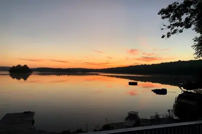 a view of a large lake at sunset at Dream Lakefront Escape + Beach/Ski/Golf near NYC in Vernon Township