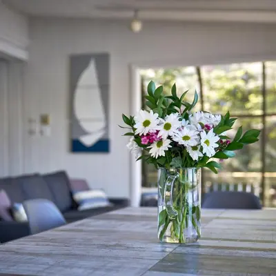 a vase of flowers sitting on a table at Dream Lakefront Escape + Beach/Ski/Golf near NYC in Vernon Township