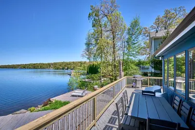 a house with a deck with a view of the water at Dream Lakefront Escape + Beach/Ski/Golf near NYC in Vernon Township